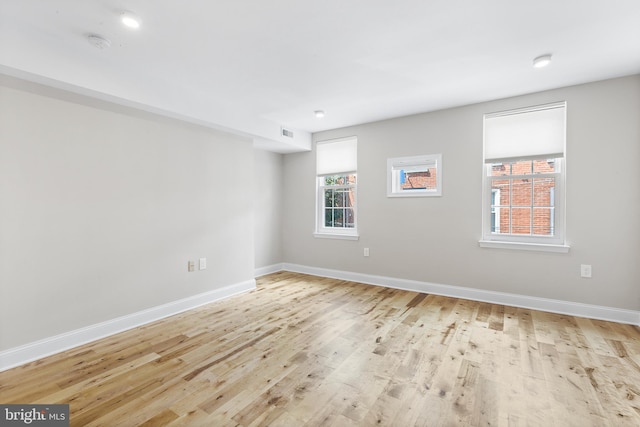 empty room with light hardwood / wood-style flooring