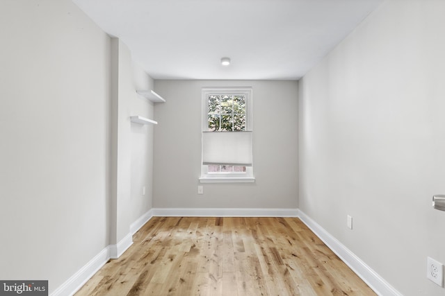 empty room with light hardwood / wood-style flooring