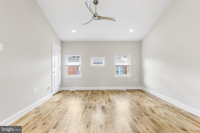 unfurnished room featuring light hardwood / wood-style floors, a wealth of natural light, ceiling fan, and lofted ceiling