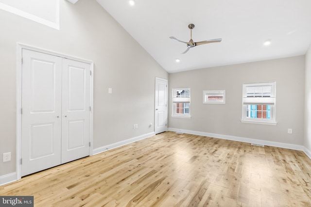 unfurnished bedroom with high vaulted ceiling, light hardwood / wood-style flooring, and ceiling fan