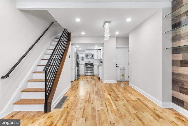 entryway with hardwood / wood-style floors