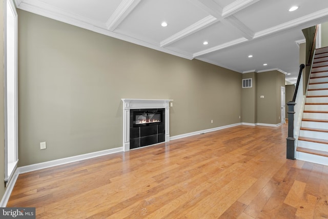 unfurnished living room with beamed ceiling, ornamental molding, coffered ceiling, and light hardwood / wood-style flooring