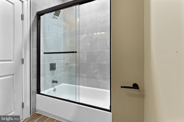 bathroom featuring shower / bath combination with glass door