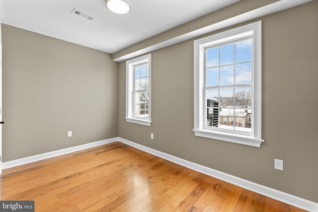 empty room with hardwood / wood-style floors