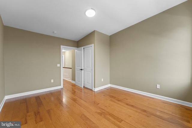 unfurnished bedroom featuring a closet and light wood-type flooring