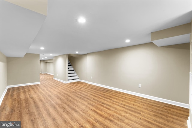 basement with light hardwood / wood-style floors