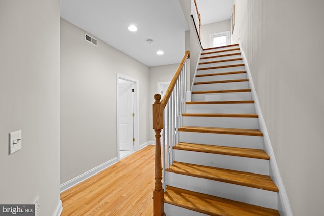 stairs with hardwood / wood-style flooring