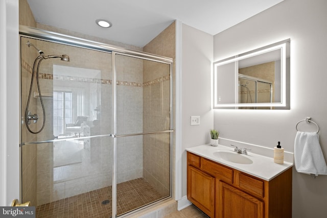 bathroom featuring vanity, an enclosed shower, and tile patterned flooring