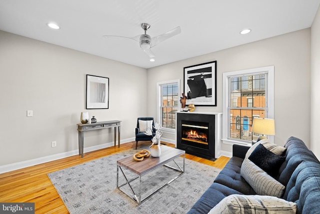 living room with ceiling fan and light hardwood / wood-style floors