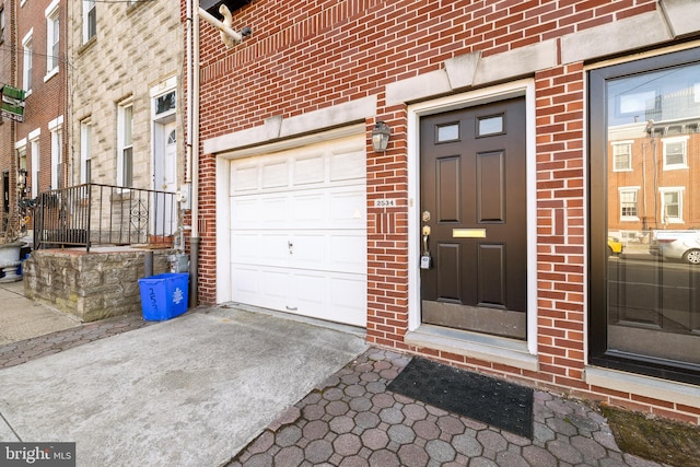 doorway to property with a garage