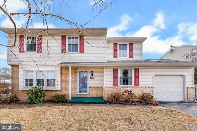 front of property featuring a garage and a front yard