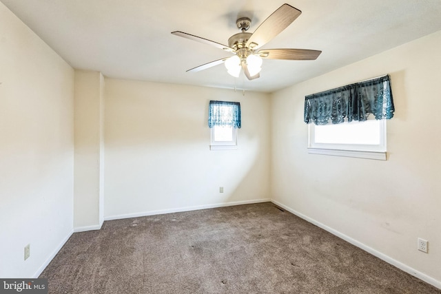 carpeted spare room featuring ceiling fan