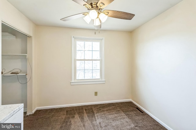 unfurnished bedroom featuring ceiling fan, a closet, and dark colored carpet