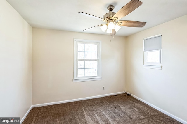 carpeted spare room with a wealth of natural light and ceiling fan