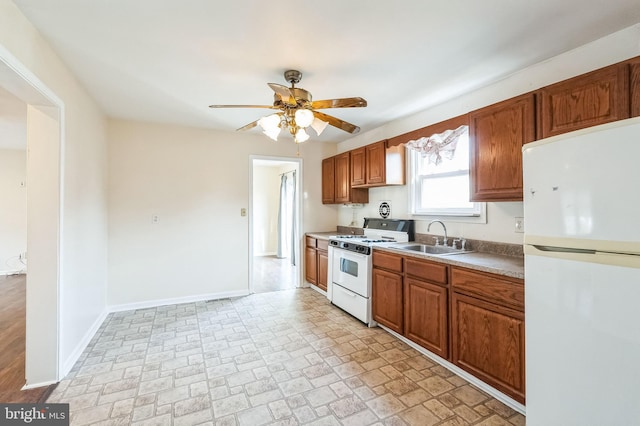 kitchen with ceiling fan, white appliances, and sink