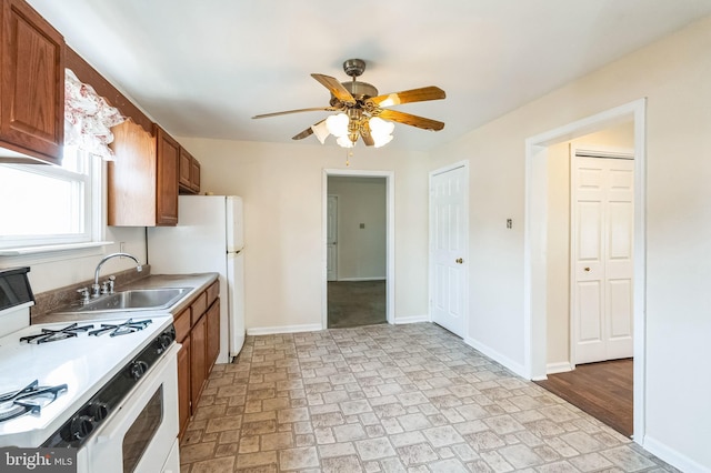 kitchen featuring ceiling fan, white appliances, and sink