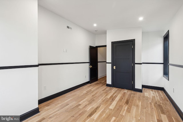 spare room with light hardwood / wood-style flooring