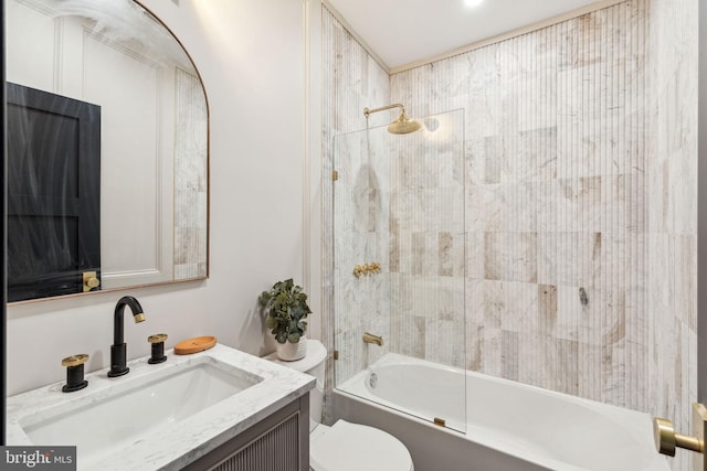 full bathroom with vanity, tiled shower / bath combo, and toilet