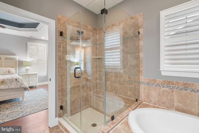 bathroom featuring shower with separate bathtub