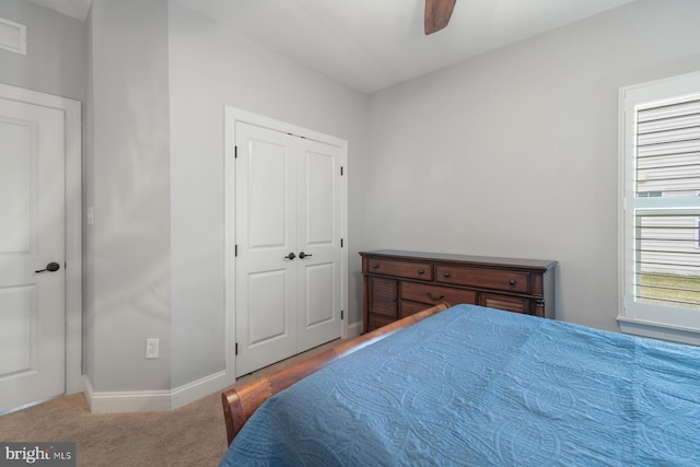 bedroom with carpet floors, a closet, and ceiling fan