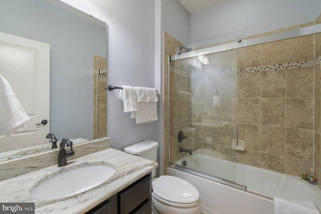 full bathroom with toilet, vanity, and bath / shower combo with glass door