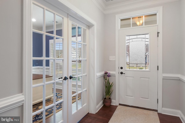 foyer entrance featuring crown molding, dark hardwood / wood-style flooring, and french doors