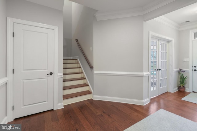 stairway with hardwood / wood-style flooring and crown molding