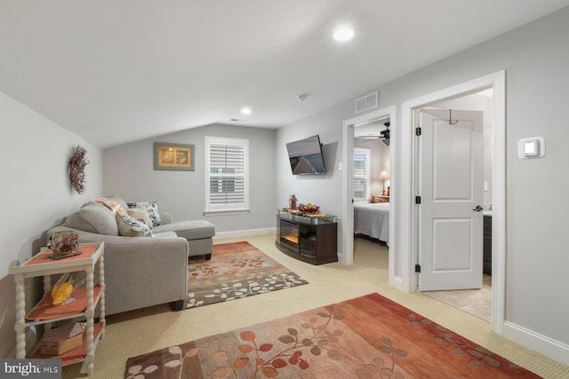 carpeted living room with vaulted ceiling