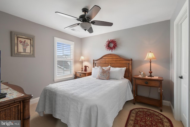 bedroom featuring light carpet and ceiling fan