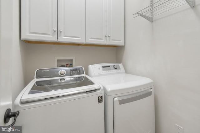 laundry area with cabinets and independent washer and dryer