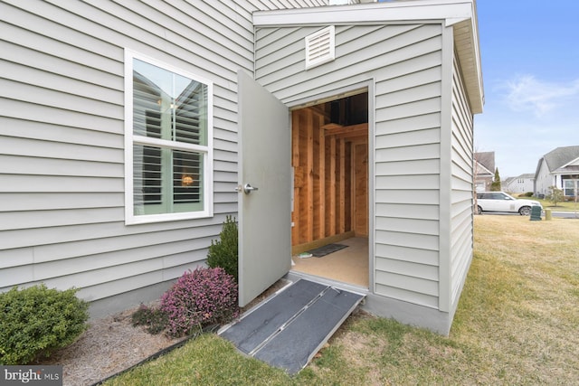 doorway to property with a yard