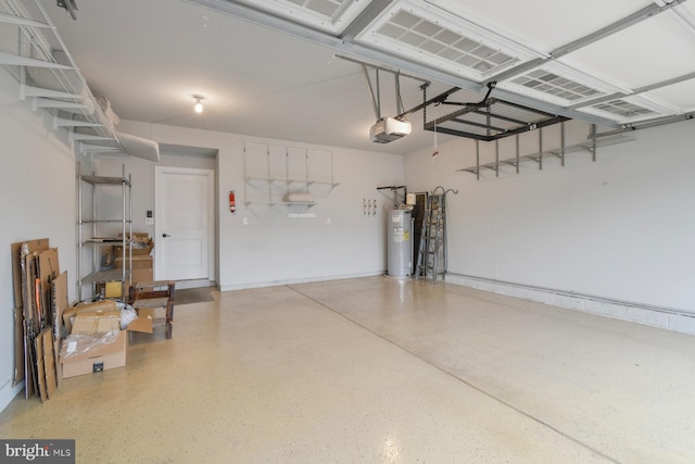 garage featuring a garage door opener and water heater