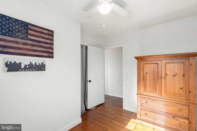 unfurnished bedroom with dark hardwood / wood-style floors and ceiling fan