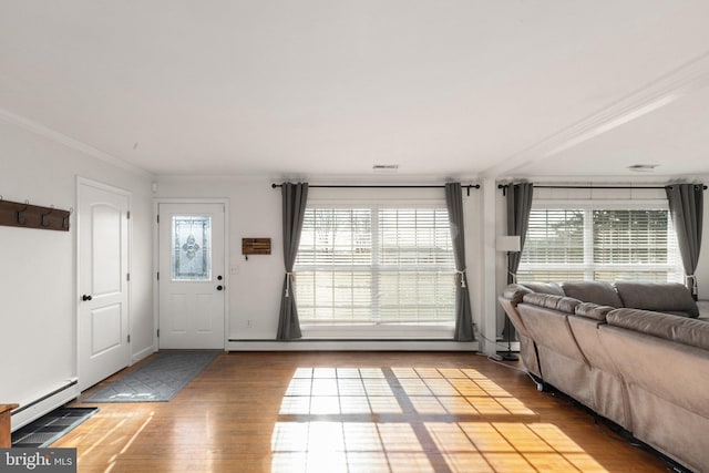 unfurnished living room featuring hardwood / wood-style flooring, ornamental molding, and a baseboard radiator