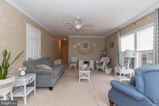 carpeted living room featuring crown molding and ceiling fan