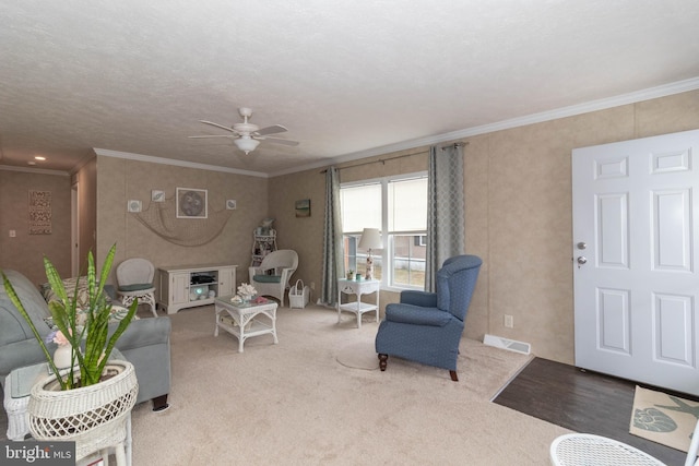 carpeted living room featuring crown molding and ceiling fan