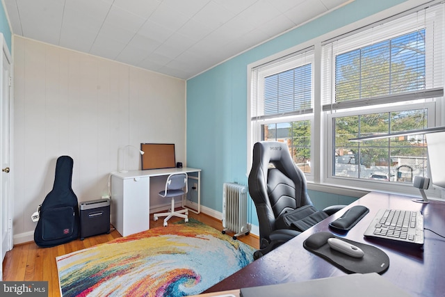 office space with radiator and light hardwood / wood-style floors