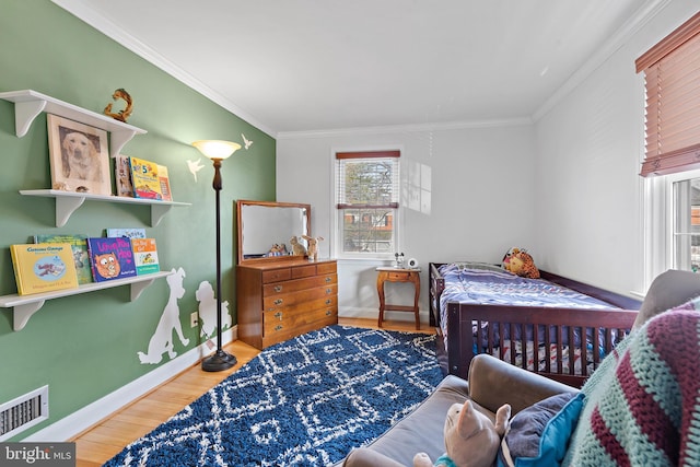 bedroom featuring hardwood / wood-style flooring and ornamental molding