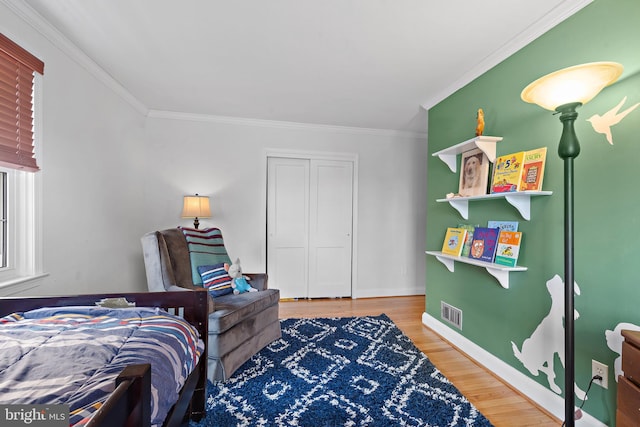 bedroom featuring hardwood / wood-style flooring and ornamental molding