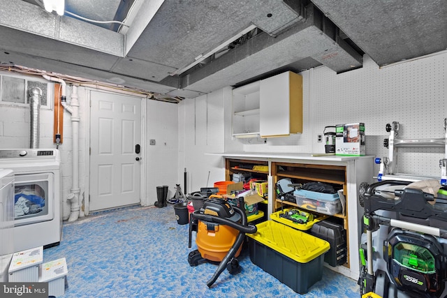 basement featuring washer / dryer and a workshop area