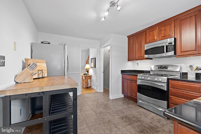 kitchen with light tile patterned floors and appliances with stainless steel finishes