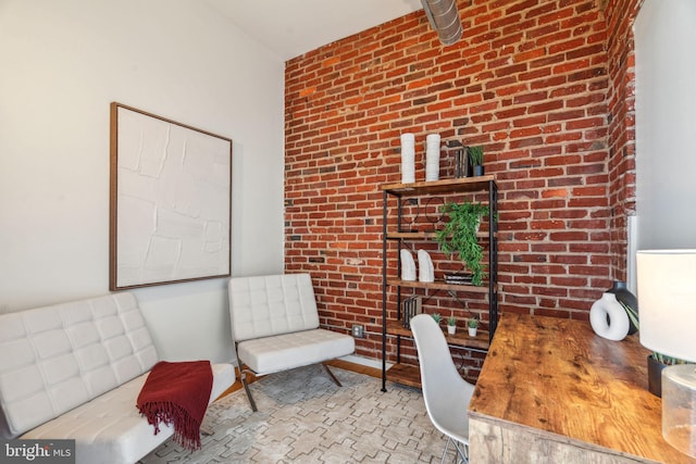 office area featuring brick wall