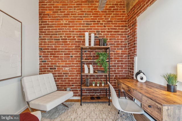 office area featuring brick wall