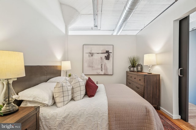 bedroom with hardwood / wood-style flooring