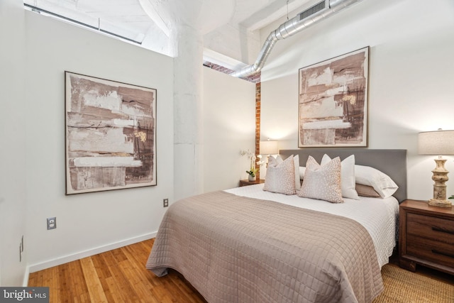 bedroom with hardwood / wood-style floors