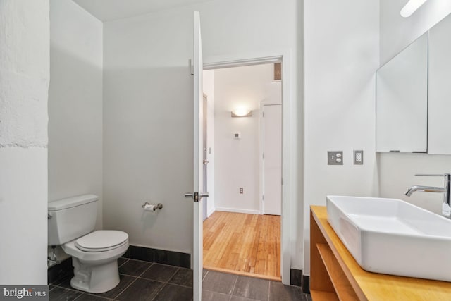 bathroom featuring sink, tile patterned floors, and toilet