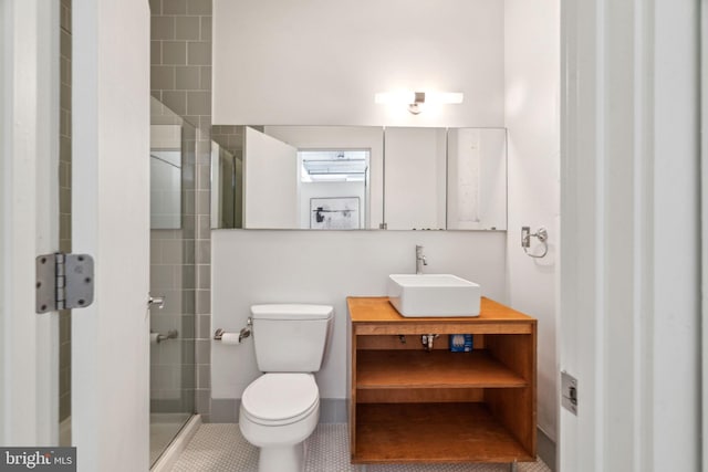 bathroom with tile patterned flooring, toilet, vanity, and a shower with shower door