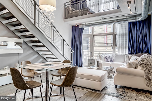 living room featuring wood-type flooring and a notable chandelier