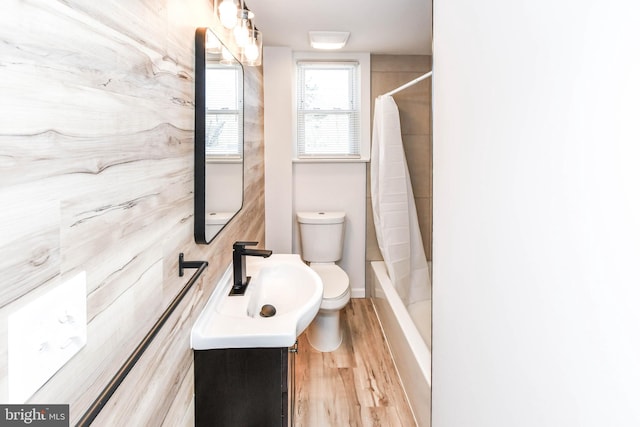 full bathroom featuring toilet, wood finished floors, and vanity