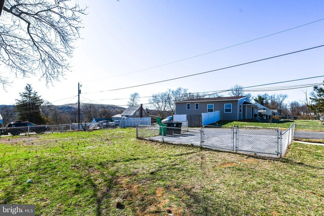 view of yard with fence and a gate